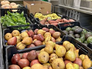 Bins of potatoes, avocados, and other produce