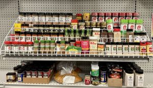 Racks of spices available to shoppers at Packed with Pride